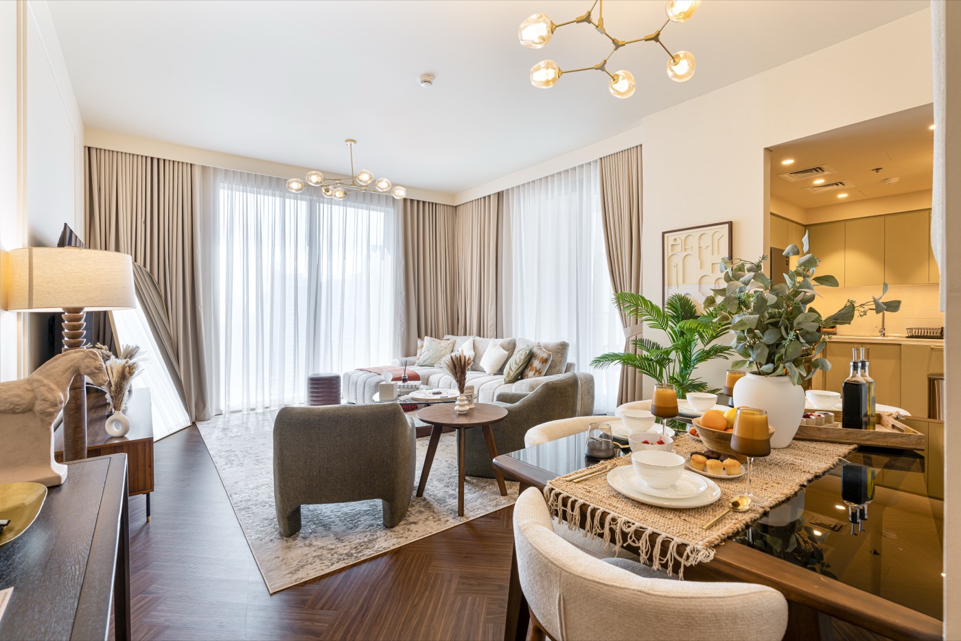 Living and dining room with the sheer curtains drawn across the window.
