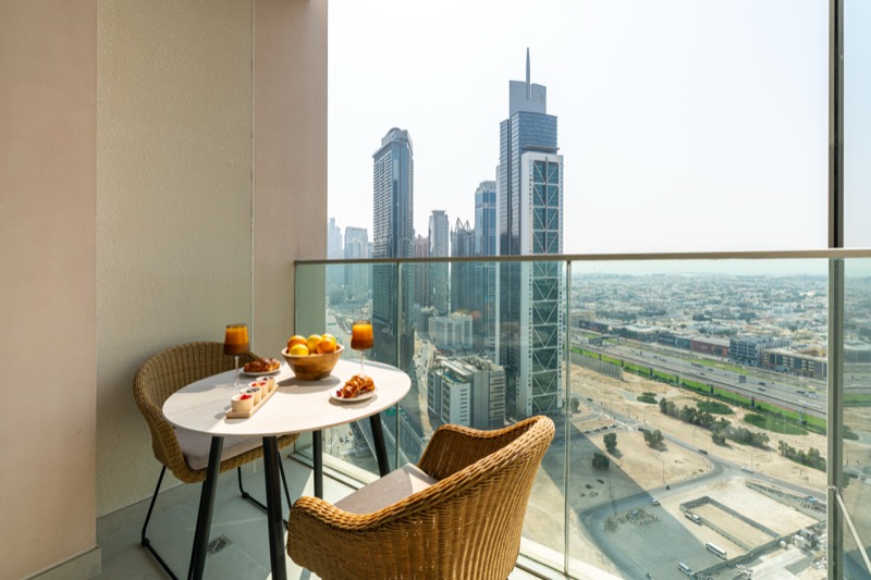 Private balcony with seating overlooking the Dubai skyline